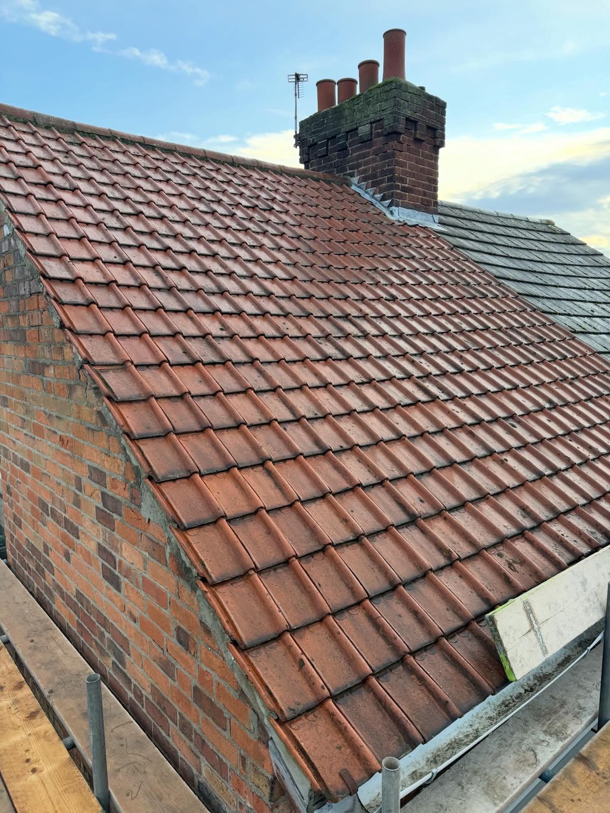 Restored pitched tile roof and chimney